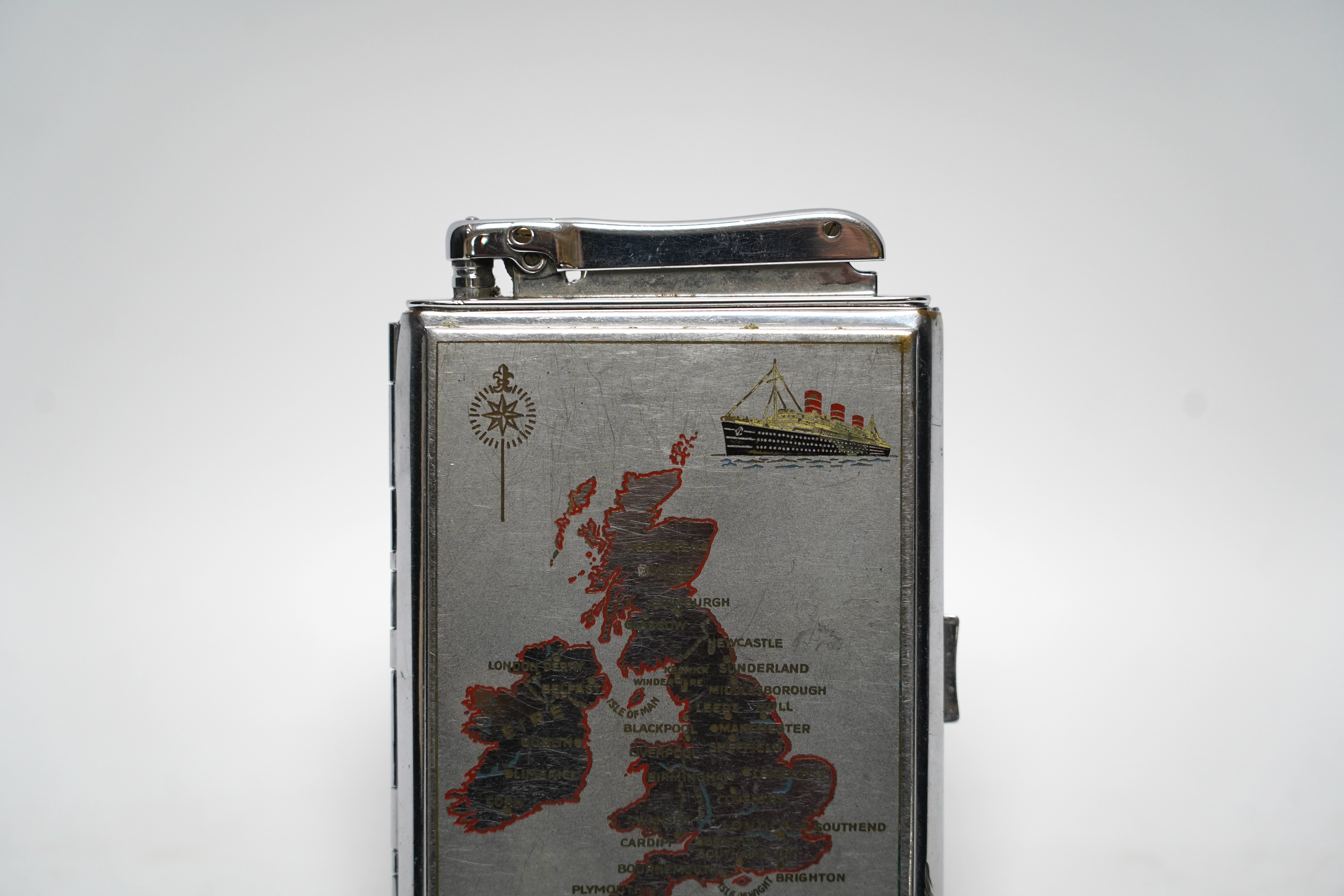 A large chrome Calibri chrome lighter and combination cigarette case with a map of the UK and a ship on the front, 12cm high